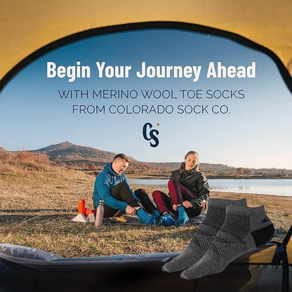 Two people sitting by a lake with merino wool toe socks from Colorado Sock Co. displayed.