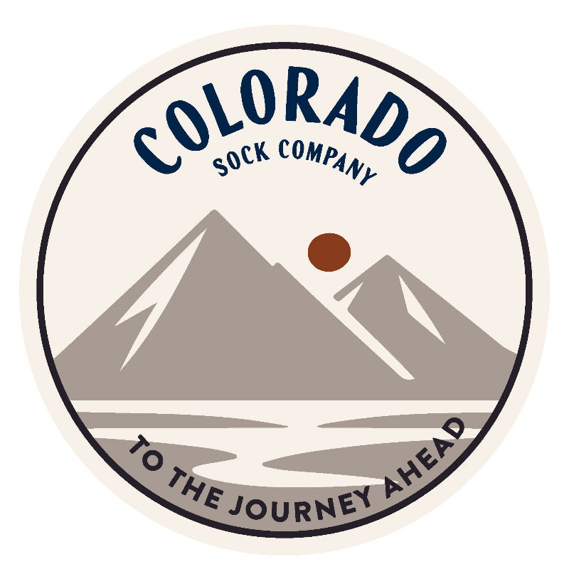Logo of Colorado Sock Company with mountains and text on a white background